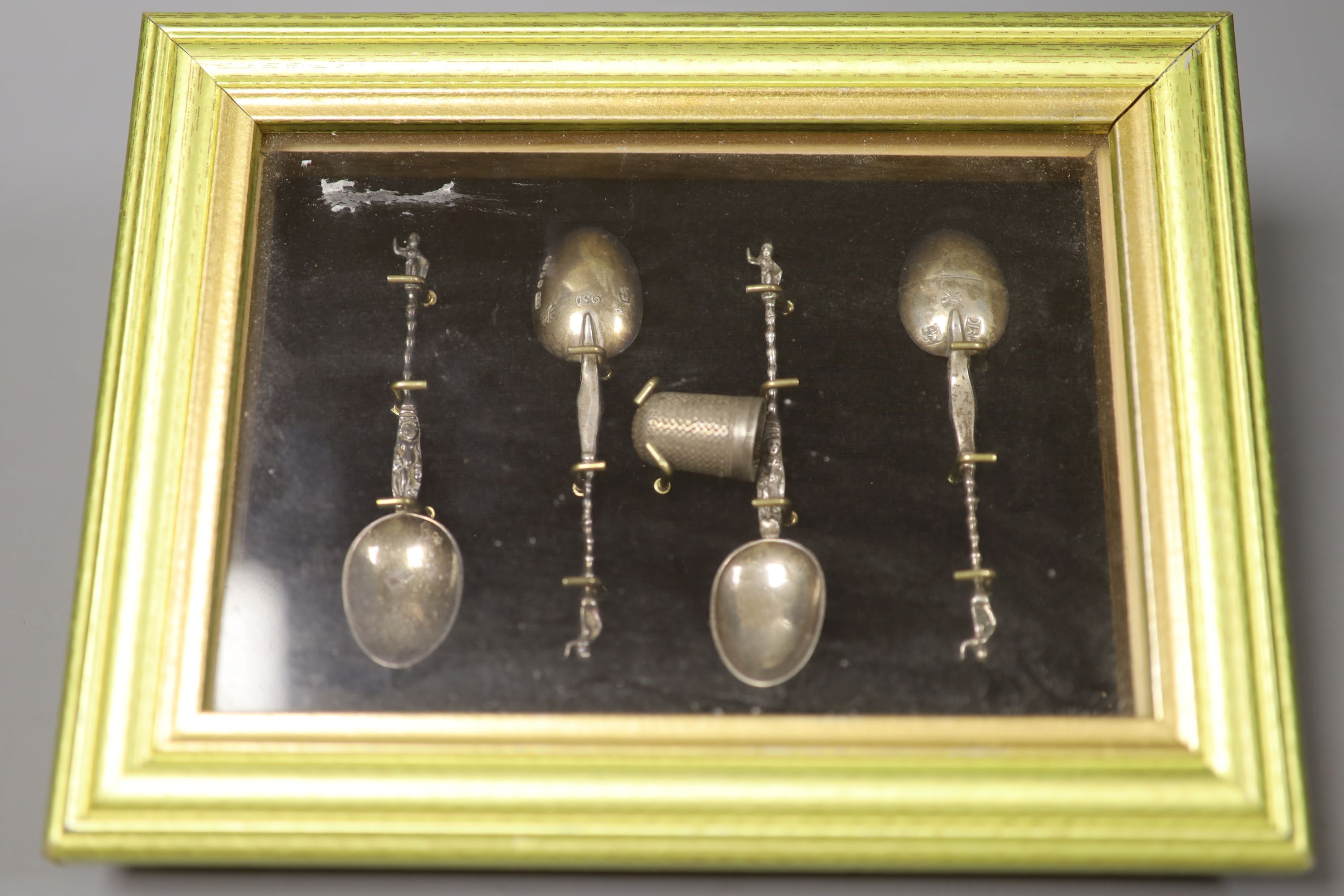 Four silver apostle spoons, a silver vesta case on chain and a silver medallion.